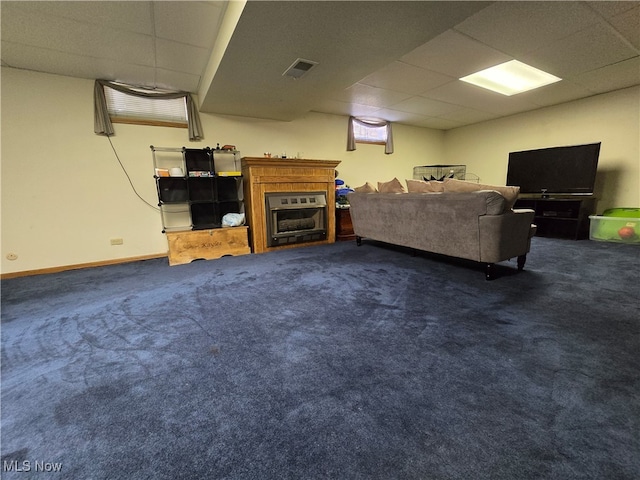 carpeted living room with a paneled ceiling