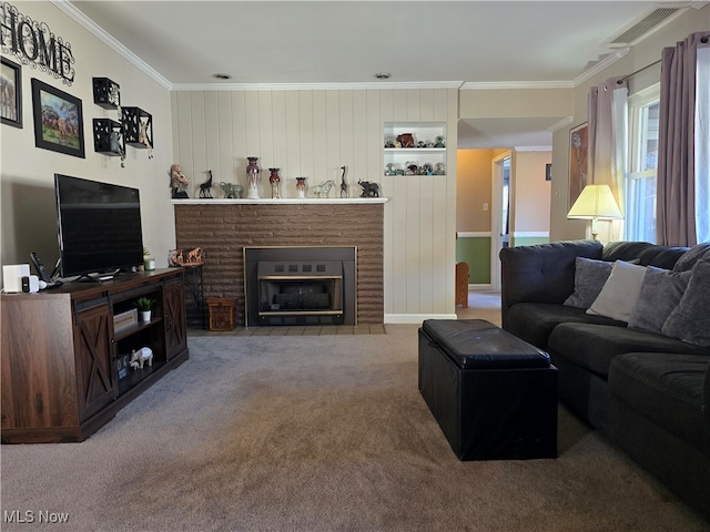 living room with ornamental molding, a brick fireplace, wooden walls, and carpet