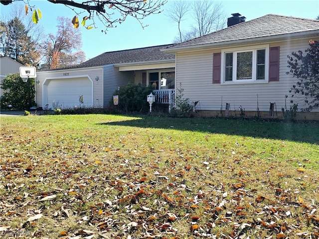 ranch-style house with a garage and a front lawn