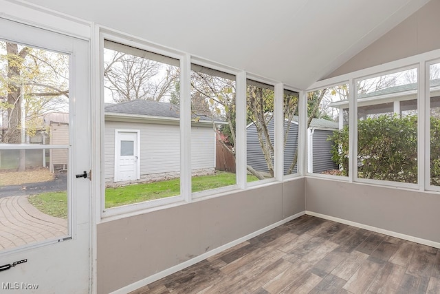 unfurnished sunroom with lofted ceiling