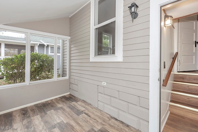 unfurnished sunroom featuring lofted ceiling