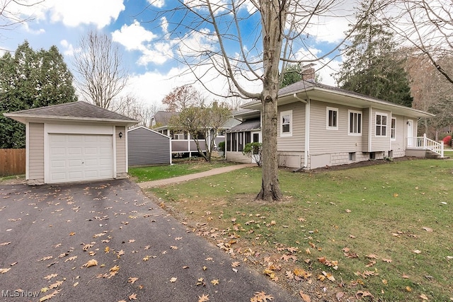 view of side of property featuring a lawn and a garage