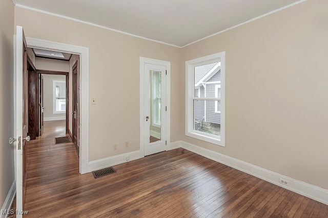 unfurnished room with ornamental molding and dark hardwood / wood-style floors