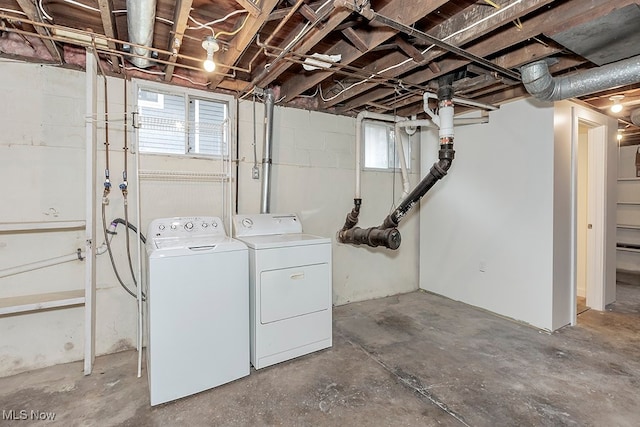 clothes washing area featuring washer and dryer