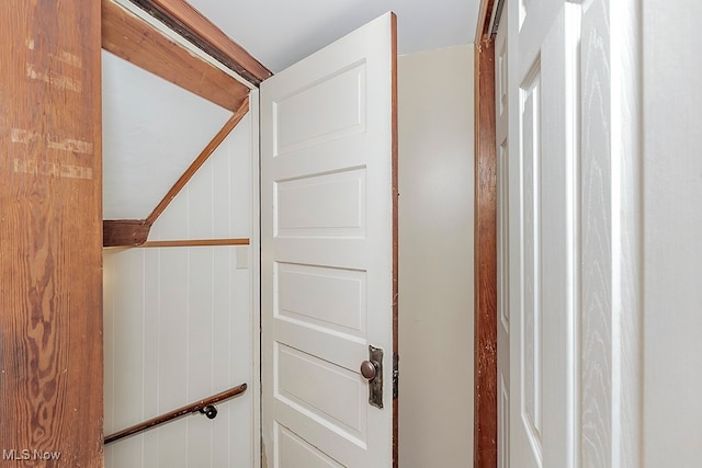 staircase with wood walls