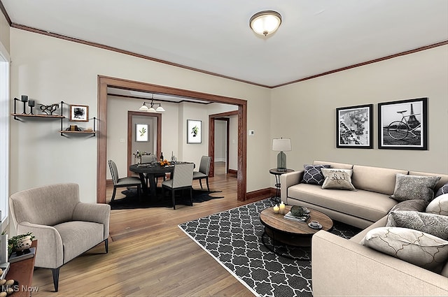 living room with wood-type flooring and crown molding