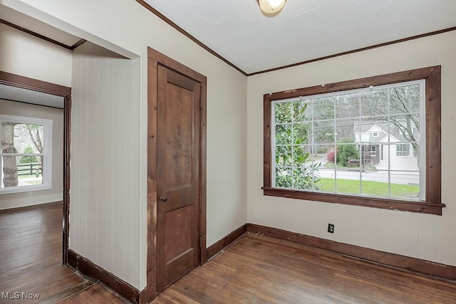 interior space with dark hardwood / wood-style flooring and crown molding