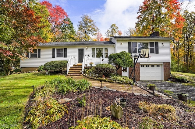 tri-level home with a garage and a front lawn