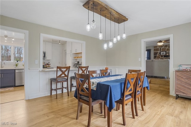 dining area with ceiling fan and light hardwood / wood-style flooring