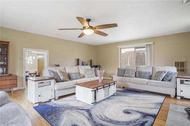 living room featuring light hardwood / wood-style floors and ceiling fan