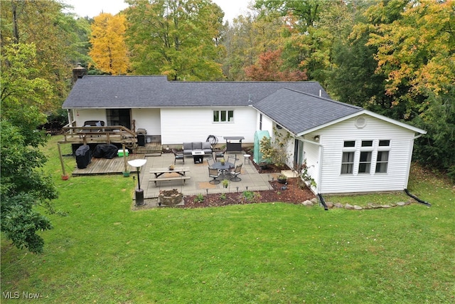 rear view of house with a wooden deck, a yard, and an outdoor hangout area