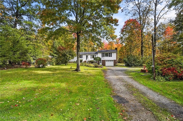 view of front of property featuring a garage and a front lawn