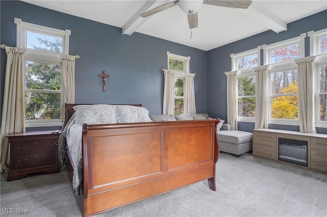 carpeted bedroom featuring ceiling fan and beam ceiling