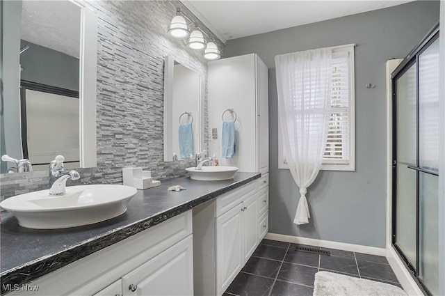 bathroom with vanity, tile patterned floors, and a shower with shower door