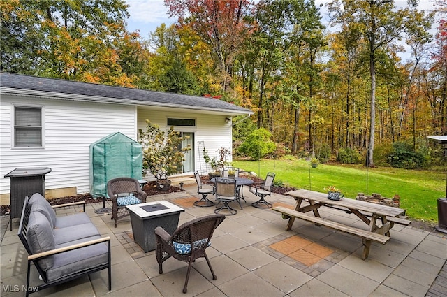 view of patio / terrace featuring an outdoor fire pit