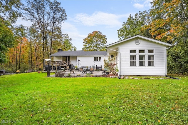 back of property featuring a yard and a patio area