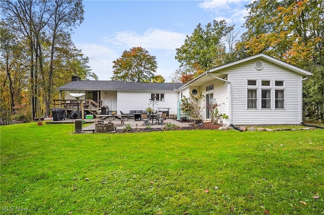 back of house featuring a patio and a yard