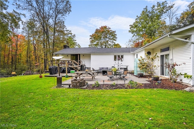 back of house with a lawn and a patio area