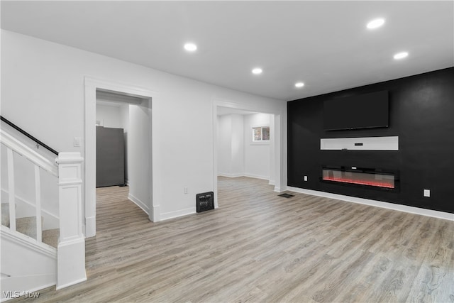 unfurnished living room featuring light hardwood / wood-style flooring