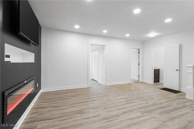 unfurnished living room featuring light hardwood / wood-style flooring