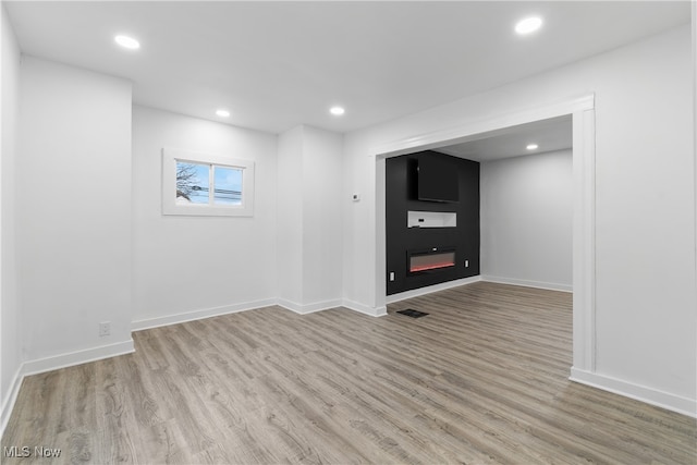 interior space featuring a fireplace and light hardwood / wood-style floors