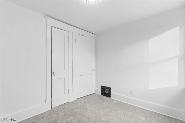 unfurnished bedroom with light carpet