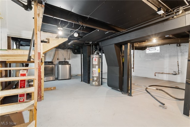 basement with water heater, heating unit, and independent washer and dryer