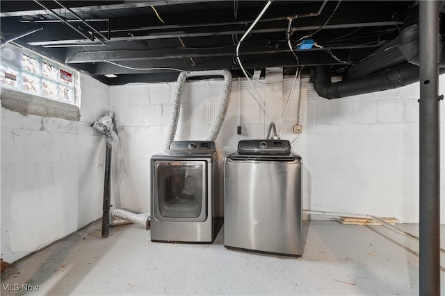 clothes washing area featuring separate washer and dryer