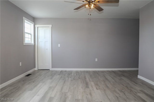 spare room with ceiling fan and light wood-type flooring