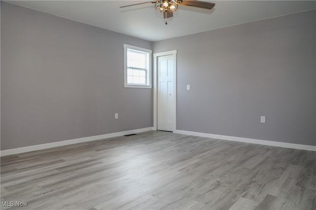 empty room featuring ceiling fan and light hardwood / wood-style flooring