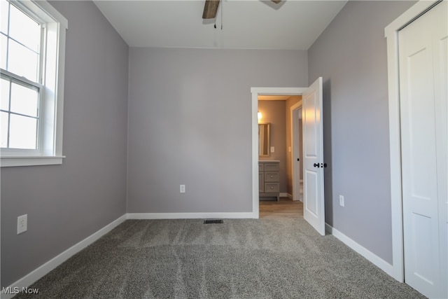 unfurnished bedroom featuring ceiling fan and carpet