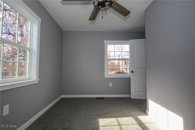 empty room with ceiling fan and carpet flooring