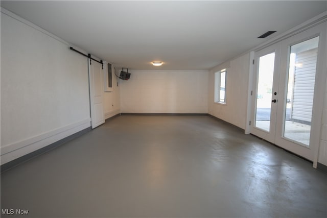 basement with a barn door and french doors