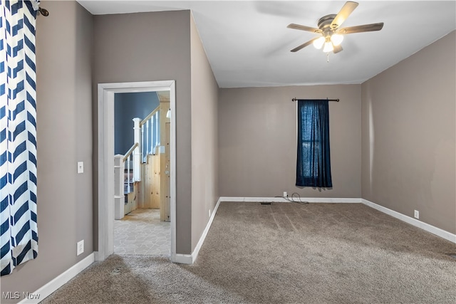 empty room with light colored carpet and ceiling fan