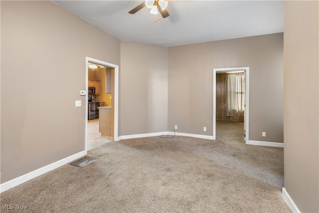 unfurnished room featuring light carpet and ceiling fan