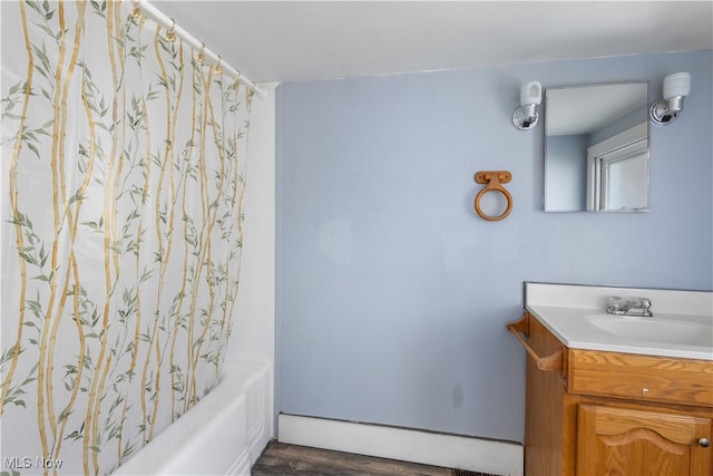 bathroom with hardwood / wood-style floors, vanity, and shower / bath combination with curtain