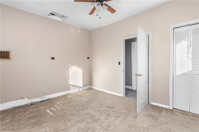 unfurnished bedroom featuring ceiling fan, a closet, and light colored carpet