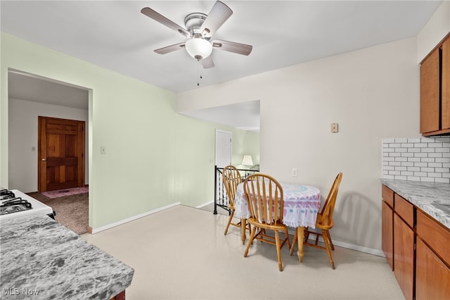 dining room with light colored carpet and ceiling fan