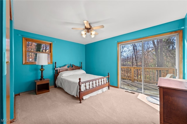 bedroom with baseboard heating, light carpet, and ceiling fan