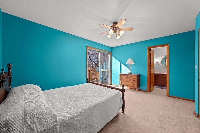 carpeted bedroom with ensuite bathroom and ceiling fan