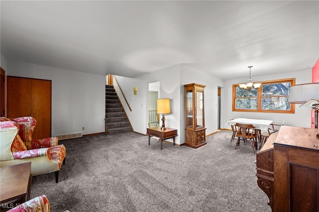 living room featuring carpet flooring and a notable chandelier