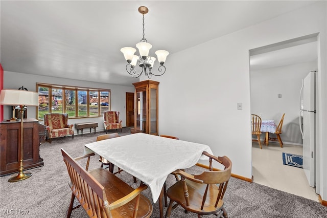 carpeted dining space with an inviting chandelier