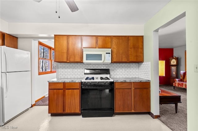 kitchen with tasteful backsplash, white appliances, light stone counters, and ceiling fan