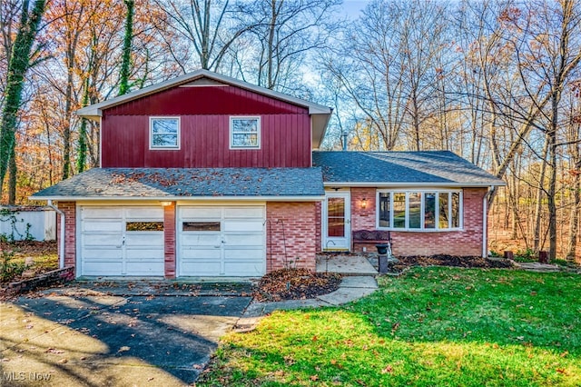 tri-level home featuring a front lawn and a garage