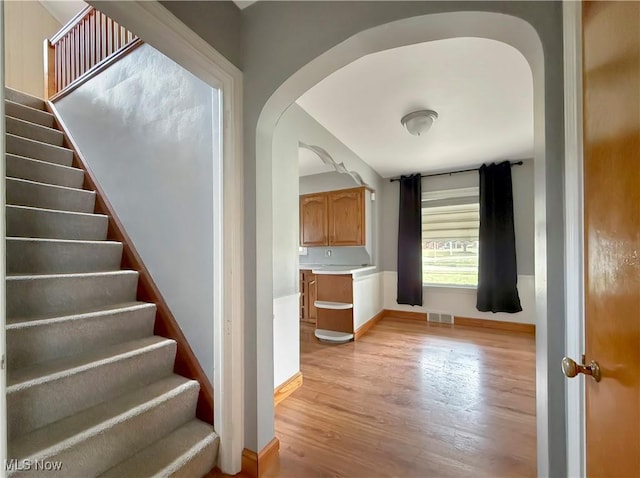 staircase with hardwood / wood-style flooring