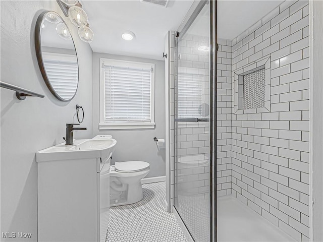 bathroom with vanity, a shower with door, toilet, and tile patterned floors