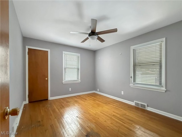 unfurnished room featuring hardwood / wood-style floors and ceiling fan