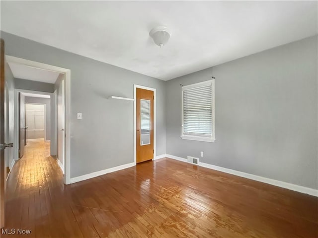 empty room featuring hardwood / wood-style flooring