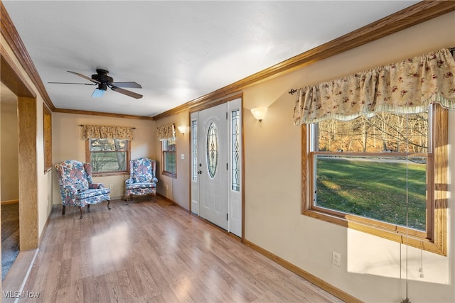 entryway featuring hardwood / wood-style floors, ceiling fan, and crown molding