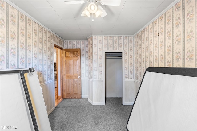 unfurnished bedroom with ceiling fan, carpet floors, and ornamental molding